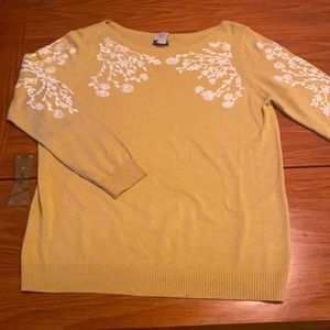 Mustard yellow sweater with white embroidered pattern on chest and arms